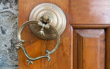 Closeup of antique copper ornate door knocker over an aged wooden door, Eyup Sultan Mosque,...
