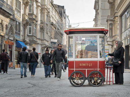 Istanbul, Turkey - April 24, 2017: Old Turkish lady buying fast food meal from a traditional Turkish...