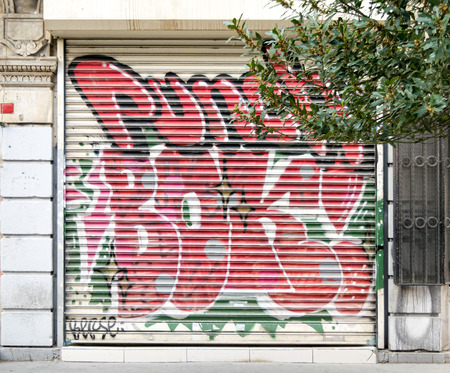 Istanbul, Turkey - April 18, 2017:  Closed shop exterior with metal door covered with colorful graffiti near Istiklal Street, Istanbul, Turkeyのeditorial素材