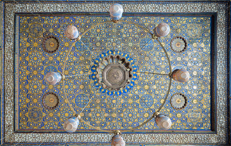 Ornate ceiling with blue and golden floral pattern decorations at Sultan Barquq mosque, Al Moez Street, Cairo, Egyptのeditorial素材
