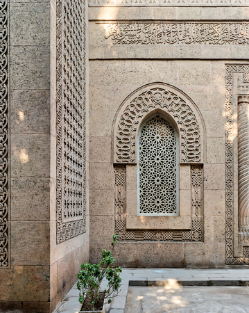 Arched window with grid of ornate marble geometric pattern in the bricks stone wall of the mosque of The Manial Palace of Prince Mohammed Ali Tewfik, Cairo, Egyptのeditorial素材