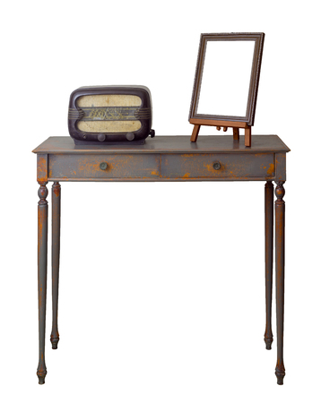 Vintage Furniture - Retro wooden vintage table with two drawers painted in grey and orange, wooden ornate brown desktop photo frame and old radioの写真素材