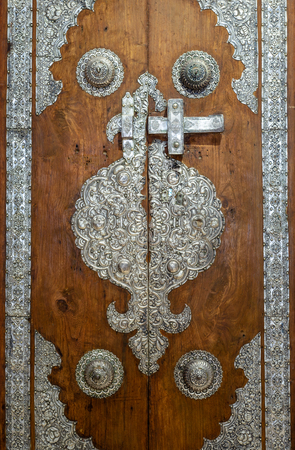 Wooden door decorated with silver plating ornaments from Sayeda Zaynap Mosque, Old Cairo, Egyptのeditorial素材