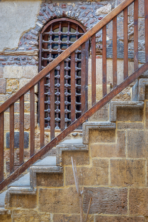 Wooden window and staircase with wooden balustrade leading to historic Beit El Set Waseela building (Waseela Hanem House), Old Cairo, Egyptのeditorial素材