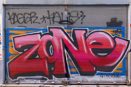 Istanbul, Turkey - April 18, 2017: Closed shop exterior with metal door covered with colorful graffiti at Hoca Tahsin Street, Karakoy district, Istanbul, Turkeyのeditorial素材