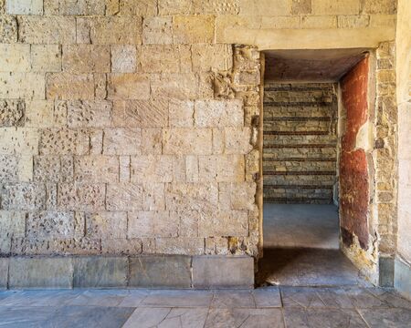 Bricks stone wall with opening revealing vacant room with bricks wall, Old Cairo, Egypt
