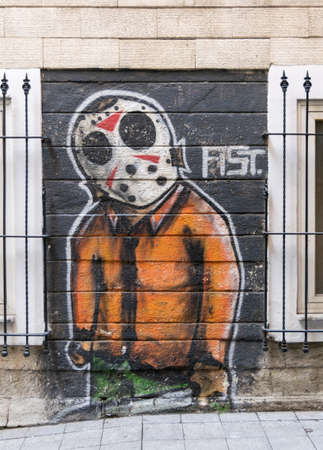 Istanbul, Turkey - April 18, 2017: Beige bricks external wall with graffiti drawing and two windows near Istiklal Streetのeditorial素材