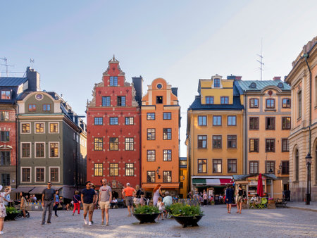 Stockholm, Sweden - June 26 2022: Stortorget, the big square, in Gamla Stan, old town, with traditional colorful old buildings on a summer day with tourists and locals walking and sitting at cafesのeditorial素材