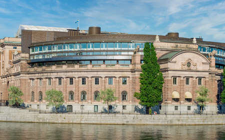 The Swedish Parliament House, Riksdagshuset, located on the island of Helgeandsholmen, Old town, or Gamla Stan, Stockholm, Sweden, in a summer dayの写真素材