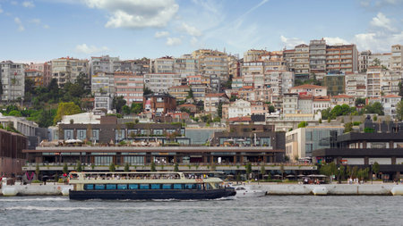 Istanbul, Turkey - September 1, 2022: Ferry boat sailing in Bosphorus Strait in front of Galataport, a mixed use development located in Karakoy neighbourhoodのeditorial素材