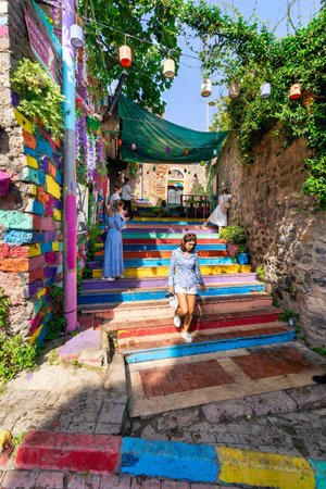 Istanbul, Turkey - August 28 2022: Tourists visiting famous traditional cafe decorated with multicolored panels and colorful stairs, suited in Balat Districtのeditorial素材
