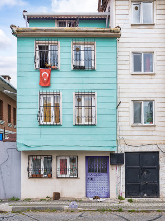 Wooden traditional residential building with a Turkish flag hanging from its window, located in Uskudar, a district of Istanbul, Turkeyの写真素材