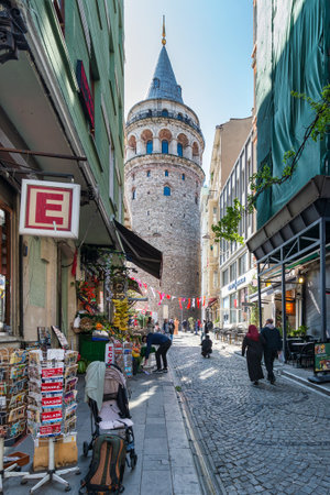 Istanbul, Turkey - May 13, 2023: Popular tourist destination Galata Tower, taken from the narrow and atmospheric cobblestone crowded Buyuk Hendek Streetのeditorial素材