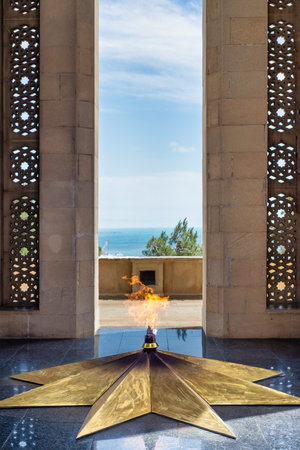 The Eternal Flame burning at Shahidlar Monument in Baku, Azerbaijan. It is on a golden star and honors those who died in the warの写真素材
