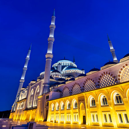Camlica Mosque, aka Buyuk Camlica Camii, in the Uskudar district of Istanbul, Turkey, illuminated at night, standing out against a deep blue sky. The minarets and domes are aglow with golden lightの写真素材