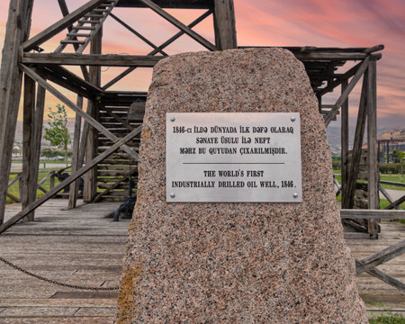 A stone monument marks the location of the worlds first industrially drilled oil well in Baku, Azerbaijan, drilled in 1846, showcasing its historical importance and the evolution of the oil industryの写真素材