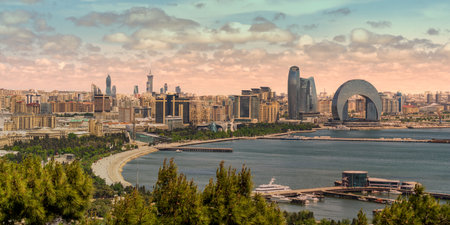 The Crescent Development Project boasts modern architecture, notably the Crescent Hotel, against a beautiful sunset on the Caspian Sea coast in Baku, Azerbaijanの写真素材