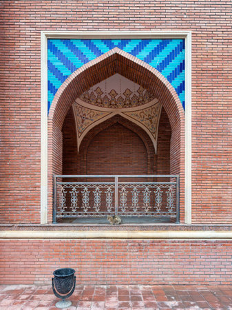 An arched balcony at the Imamzadeh Mausoleum in Ganja, Azerbaijan, an architectural marvel characterized by its captivating red brickwork and intricate blue tileworkの写真素材