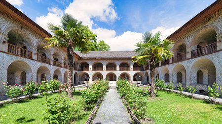The Upper Caravanserai courtyard in Shaki, Azerbaijan, boasts stunning architecture with arched...