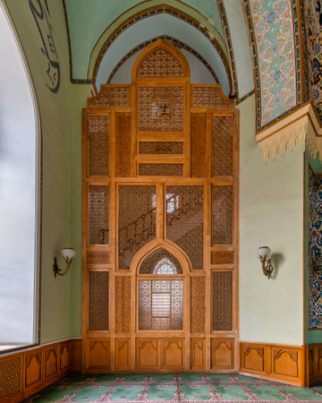 Beautifully crafted wooden screen and ornate wall patterns at Taza Pir Mosque in Baku, Azerbaijan. The mosque showcases stunning architectural details and rich cultural heritageの写真素材