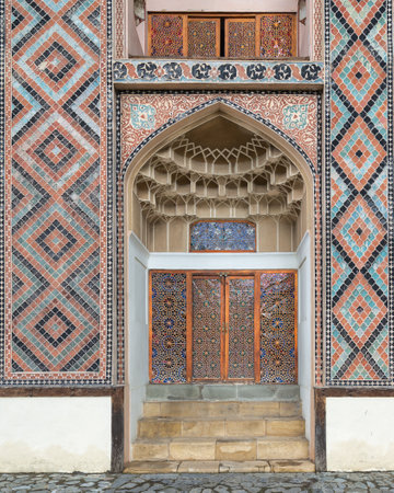 A meticulously crafted side entrance to Shaki Khan Palace, adorned with vibrant tile patterns and exuding elegance in the Shaki architectural style of Azerbaijanの写真素材