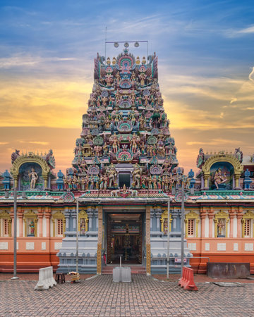 Sri Kandaswamy Kovil stands magnificently, showcasing intricate carvings and vibrant colors as the sun sets. The towering gopuram highlights the temples artistic detail, Kuala Lumpur, Malaysiaの写真素材
