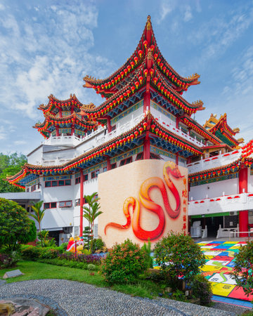 Thean Hou Temple, a Chinese Buddhist temple in Kuala Lumpur, Malaysia. Features traditional architecture, tiered roofs with red lanterns, snake mural, and garden pathの写真素材