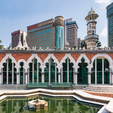 Kuala Lumpur, Malaysia - Feb. 17, 2025: Historic Masjid Jamek Sultan Abdul Samad mosque architecture contrasted with modern skyscrapers in downtownの写真素材