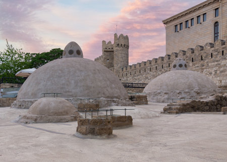 Ancient hammam domes within Icherisheher, or Old City walls and a tower at sunset in Baku, Azerbaijanの写真素材