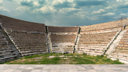 Ancient Roman Theater of Pergamon, Bergama, Turkey. Stone tiers, grassy arena, cloudy sky. Historical siteの写真素材