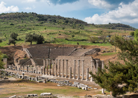 Ancient Asklepion ruins in Bergama, Turkey. View of the Roman theater and Sacred Way columns amidst...