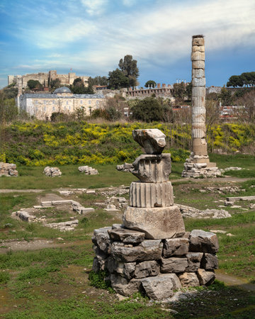 The ancient Temple of Artemis, aka The Artemision, ruins with standing column and stork nest, Isa Bey Mosque, and Ayasuluk Castle in Selcuk, Turkeyの写真素材