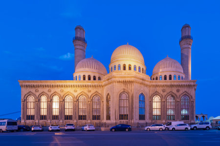 Bibi-Heybat Mosque at night in Baku, Azerbaijan. Illuminated Islamic architecture featuring domes and minarets under a deep blue skyの写真素材