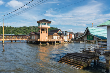 Kampong Ayer Cultural and Tourism Gallery with its observation tower in Kampong Ayer, Bandar Seri Begawan, Brunei. Water village architecture under a bright blue skyの写真素材