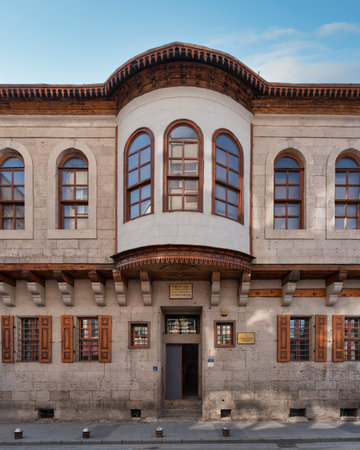 Historic Ataturk House Museum in Kayseri, Turkey. Stone facade with ornate wooden bay window, arched windows, and decorative eavesの写真素材