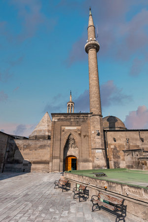 Historic Seljuk Hunat Mosque, Hunat Camii, with its towering minaret and ornate entrance, under a blue sky in Kayseri, Turkeyの写真素材