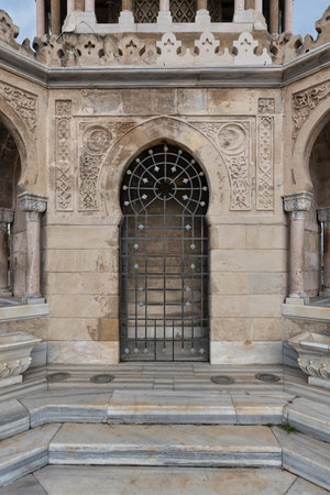 Detailed view of the ornate entrance of Izmir Clock Tower, Konak Square, Izmir, Turkey. Features intricate stone carvings, an arched doorway, and a decorative iron gate.の写真素材
