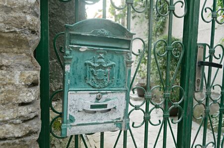 Old green iron mailboxes on the doors of a house in Herceg Novi, Montenegroの写真素材