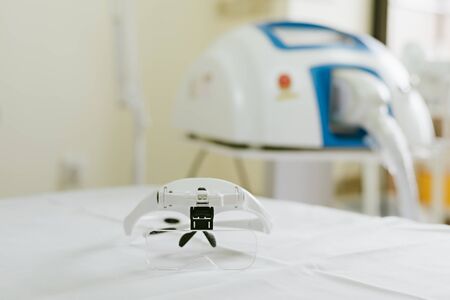 Magnifying glasses with adjustable LED lighting for individual eyelash extensions. Background image. Fashion and beauty concept.の写真素材