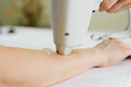Close-up photo of hair removal of a female hand in a beauty salon. Cosmetology and SPA concept
の写真素材