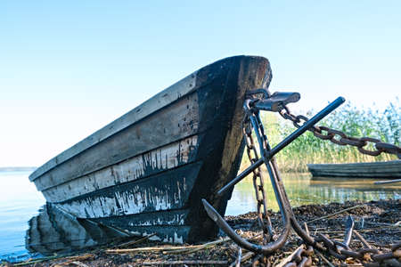 Abandoned old wooden fishing boats on the shore on a summer sunny dayの写真素材