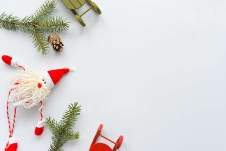 Flat lay composition Toy santa with sleigh and christmas tree on white background. Christmas and winter concept. Copy space for textの写真素材