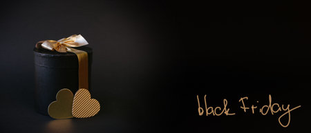 Black Friday Sale. Black gifts box with gold bowの写真素材