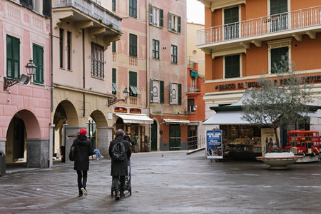 Married couple with a stroller walks through a beautiful Mediterranean town: SANTA MARGHERITA LIGURE, ITALY - January 27, 2020のeditorial素材
