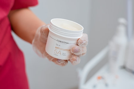 Beautician holds jar of silk threads for facelift from Christina. Non-surgical cosmetology. Israeli cosmetics: Minsk, Belarus - 21.07.2022のeditorial素材