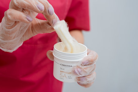 Beautician holds jar of silk threads for facelift from Christina. Non-surgical cosmetology. Israeli cosmetics: Minsk, Belarus - 21.07.2022のeditorial素材