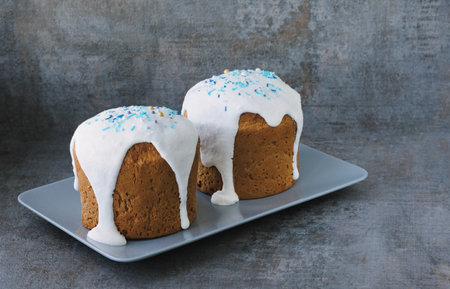 Happy easter. Traditional glazed Easter cakes on dark textured background
