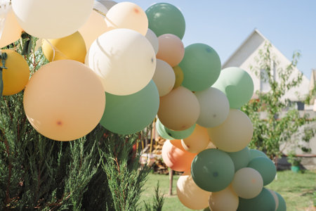 Balloons prepared for holiday in courtyard of country house in sunlightの写真素材