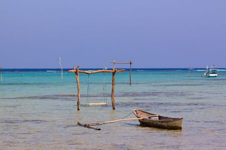 Little boat and swining pole in the water of the pristine coasts of Karimunjawa,Java, Indonesia