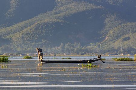 Inle Lake, Myanmar, November 20 2018 - Authentic fishermen working checking their nets on the waters of Inle Lake.の写真素材